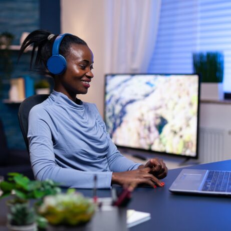 Cheerful black woman listening music