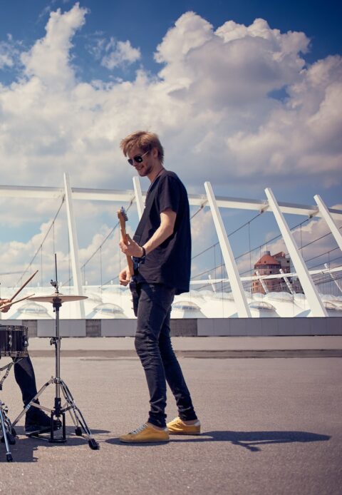 rock band in black clothing playing music on street