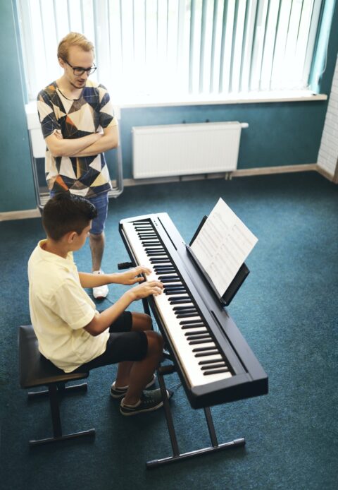 Teacher and student in the classroom of music school