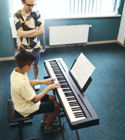 Teacher and student in the classroom of music school